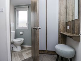 A bathroom with a toilet and sink at Puffin in St Bees
