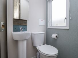 A bathroom with a sink and toilet at Puffin in St Bees