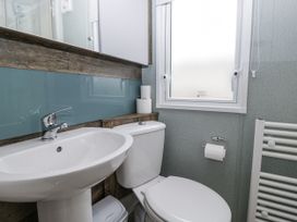 A bathroom with a sink and toilet at Puffin in St Bees