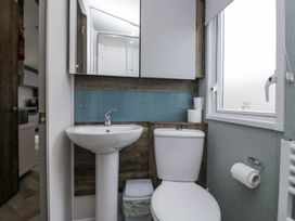 A bathroom with a sink and toilet at Puffin in St Bees