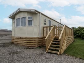 A mobile home with wooden steps in St Bees at Puffin