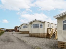 Three caravans near a driveway at Puffin in St Bees