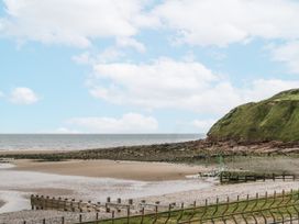 An outdoor view of a beach and cliff at Puffin in St Bees