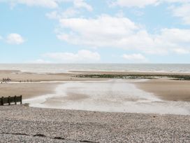 A beach view with clouds and a tidal area at Puffin St Bees