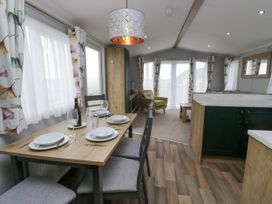 A dining area with a table and chairs at Sandpiper in St Bees