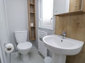 A bathroom with a toilet and sink at Sandpiper in St Bees