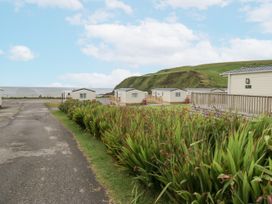 An outdoor area with caravans and a road at Sandpiper in St Bees