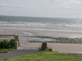 A beach leading to the ocean with steps at Sandpiper in St Bees