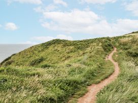 A path on a grassy hill overlooking the sea at Sandpiper in St Bees
