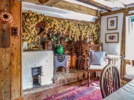 A living room with a fireplace and wooden beams at Bank House