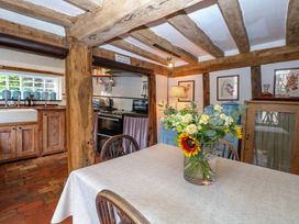A kitchen with a table and flowers at Bank House