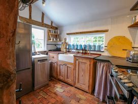 A kitchen with a refrigerator, sink, and stove at Bank House