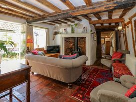 A living room featuring a sofa, armchair, fireplace and television at Bank House