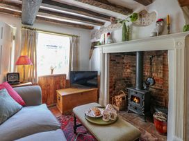 A living room with a fireplace and sofa at Bank House