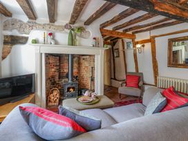 A living room with a fireplace, sofa, and television at Bank House