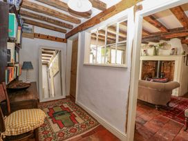 A hallway with a bookshelf and a mirror at Bank House in 