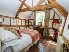 A bedroom with a bed and wooden furniture at Bank House in 
