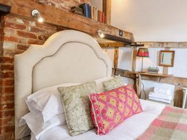 A bedroom with a bed and bedside lamp at Bank House