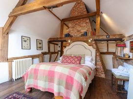 A bedroom with a bed and wooden beams at Bank House
