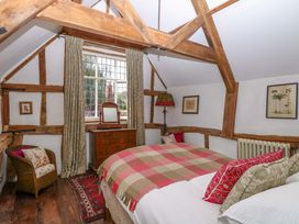 A bedroom with a bed and wooden furniture at Bank House in 
