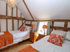 A bedroom with two beds and a window at Bank House 