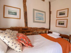 A bedroom with a bed and artwork on the wall at Bank House 