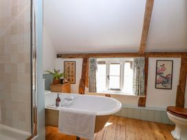 A bathroom with a bathtub and a window at Bank House