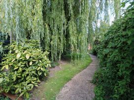 A garden with a pathway surrounded by plants at Bank House