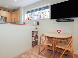 A kitchen with a table and chairs at Mini Mena St Austell