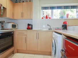 A kitchen with appliances and cabinets at Mini Mena St Austell
