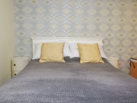 A bedroom with a bed and pillows at Mini Mena in St Austell