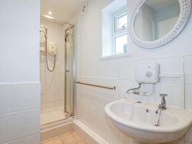 A bathroom with a shower and sink at Mini Mena St Austell