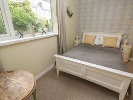 A bedroom with a bed and decorative elements at Mini Mena in St Austell