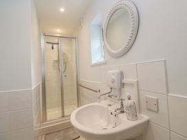 A bathroom with a sink and shower at Mini Mena in St Austell