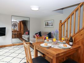 A dining room with a table set for breakfast at Church Barn in Sutcombe near Bradworthy