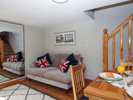 A living room with a sofa and dining table at Church Barn in Sutcombe near Bradworthy