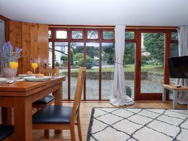 A dining room with a table and chairs at Church Barn Sutcombe near Bradworthy