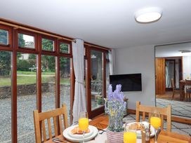 A dining room with a table set for breakfast at Church Barn Sutcombe near Bradworthy