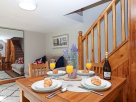 A dining room with a table set for breakfast at Church Barn in Sutcombe near Bradworthy