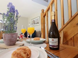 A dining table with croissants and drinks at Church Barn Sutcombe near Bradworthy