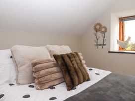 A bedroom with pillows on a bed at Church Barn in Sutcombe near Bradworthy