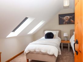A bedroom with two beds and a painting at Church Barn in Sutcombe near Bradworthy