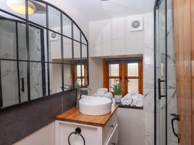 A bathroom with a sink and towels at Church Barn in Sutcombe near Bradworthy