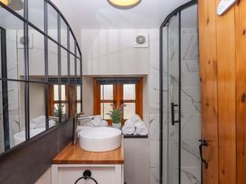 A bathroom with a sink and shower at Church Barn in Sutcombe near Bradworthy