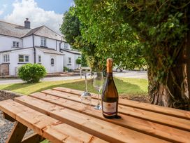 A table with a bottle of Prosecco and glasses at Church Barn Sutcombe near Bradworthy