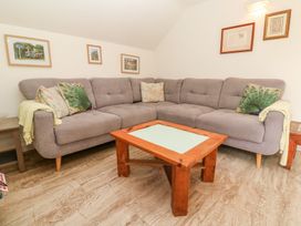A living room with a sofa and coffee table at Five Elements Barn in Truro