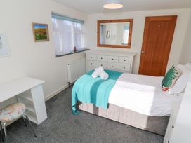 A bedroom with a bed and study desk at Five Elements Barn in Truro