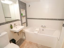 A bathroom with a bathtub and sink at Five Elements Barn in Truro