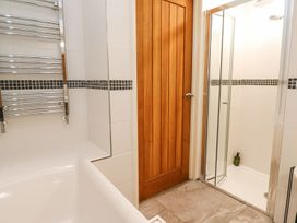 A bathroom with a bathtub and a shower at Five Elements Barn in Truro