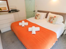A bedroom with a bed and dresser at Five Elements Barn in Truro